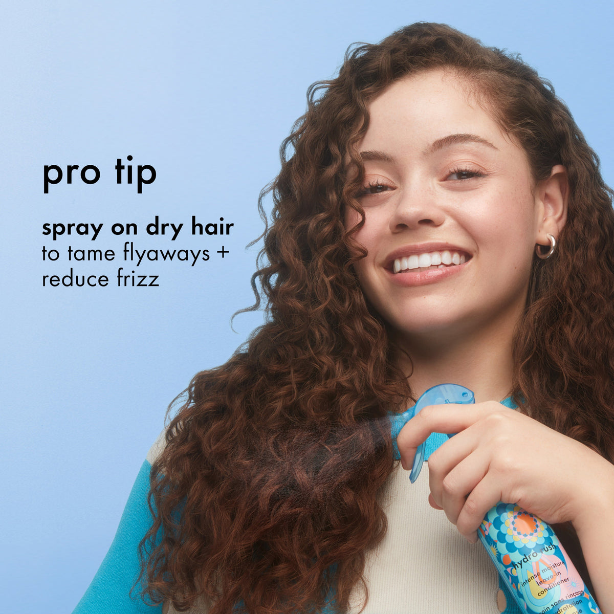 Applying amika Hydro Rush leave-in conditioner to curly hair