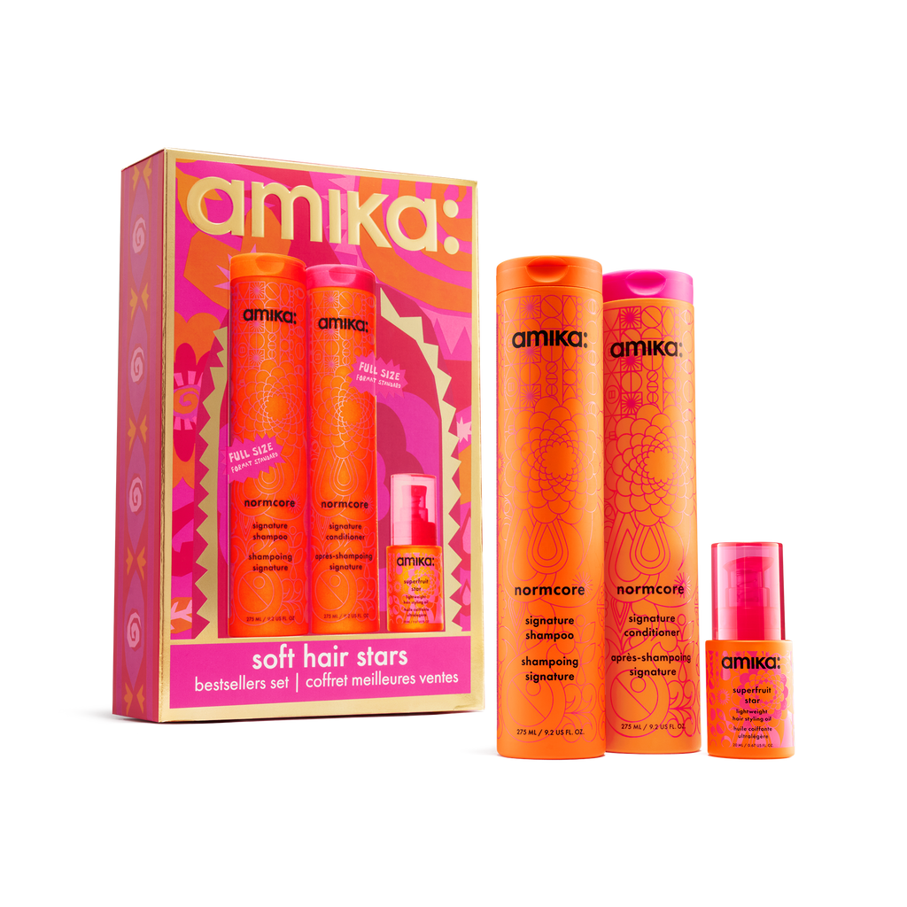 amika Soft Hair Stars set with Normcore shampoo and conditioner and Superfruit Star hair oil beside the gift box